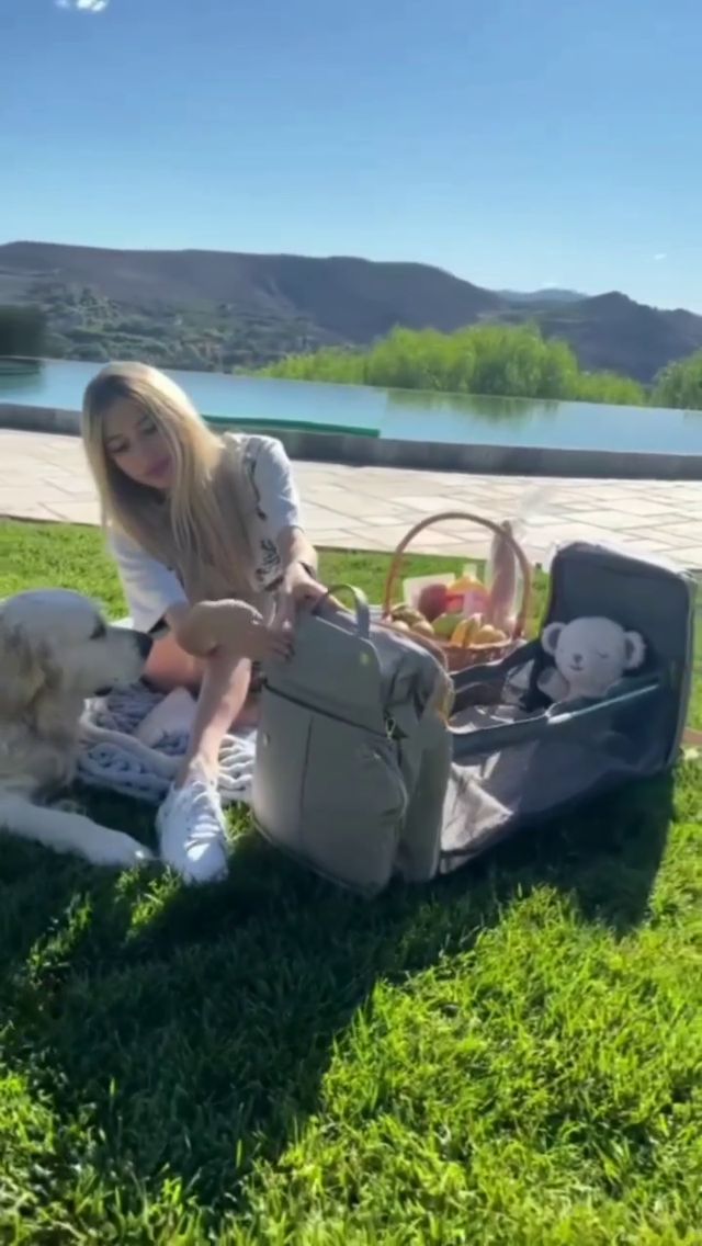 Creator outdoors with a diaper bag and picnic setup